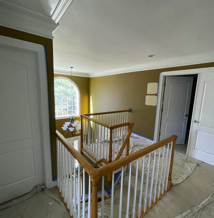 Foyer entryway before professional repainting - original condition.